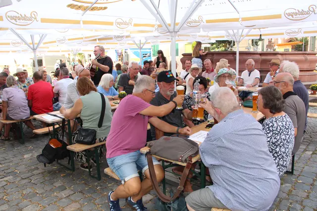 Beim Kerwe-Hock stießen die Mitglieder der SPD (vorne) und die CDU (hinten) auf einen netten Kerwe-Abend an, der von Andreas Lange an der Gitarre begleitet wurde. 